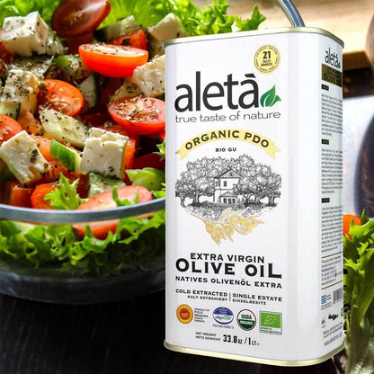 ELLORA FARMS Aleta organic PDO Messara extra virgin Greek olive oil 1 liter tin next to a fresh Greek salad