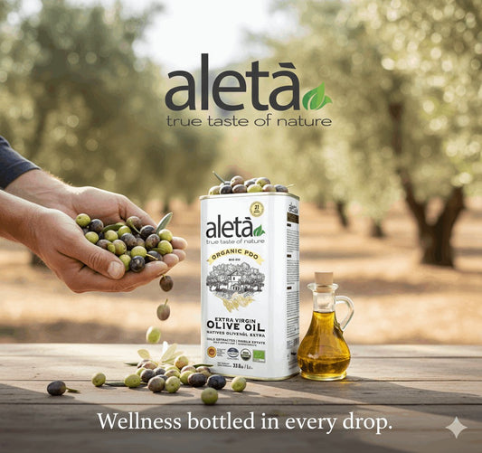 ELLORA FARMS Aleta organic PDO extra virgin olive oil tin with fresh olives held by hands in a sunny olive grove