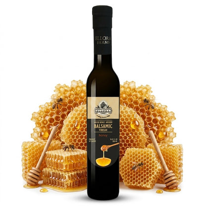 ELLORA FARMS Greek honey infused balsamic vinegar bottle displayed with honeycomb and wooden honey dippers.