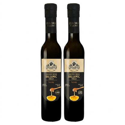 Two bottles of ELLORA FARMS Greek honey infused balsamic vinegar with a honey dipper graphic on the label.